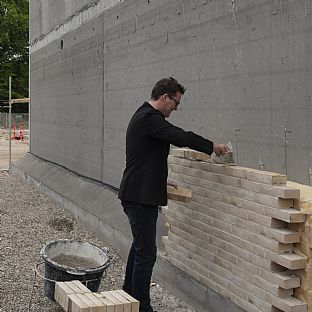 Michael Kruse, architect and Partner at C.F. Møller Architects, laying the foundation stone at Dalum Paper factory. - New life to old industrial area at Dalum Paper Factory in Odense - C.F. Møller. Photo: C.F. Møller Architects