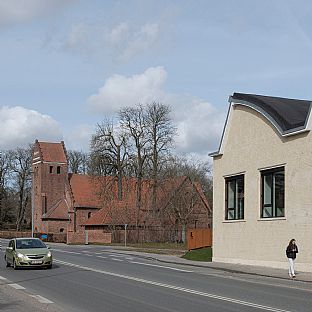 The facade towards Dalumvej after the transformation. Impressive vaulted shed roofs are preserved as a landmark of the new district at Dalum Paper factory by C.F. Møller Architects. - Nyt liv til gammelt industriområde ved Dalum Papirfabrik i Odense - C.F. Møller. Photo: Michael Kruse